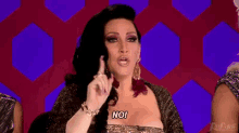a woman with long black hair is making a funny face and saying no .