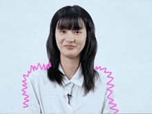 a woman wearing a white shirt has a pink drawing of a wave on her shoulder