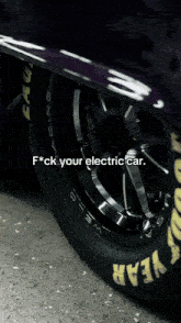 a close up of a car wheel with the words " f * ck your electric car " on it