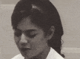 a close up of a woman 's face with her eyes closed .
