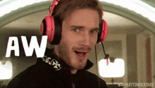 a man wearing headphones with the word aw on the screen