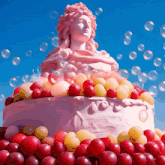 a statue of a woman is surrounded by fruit and bubbles