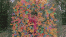 a man in a pink shirt is surrounded by colorful bubbles