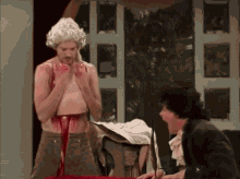 a man in a white wig is standing next to a man with blood on his pants