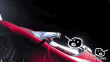 a red car is flying through space with og 76ed written on the bottom