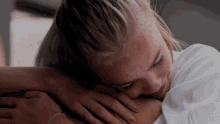a woman is laying down with her head on another woman 's lap
