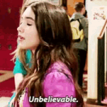 a girl in a purple jacket is saying unbelievable