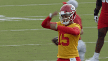 a football player with the number 5 on his jersey stands on the field