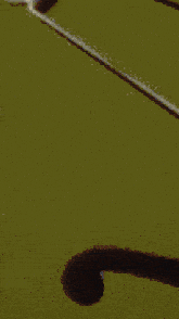 a pixelated image of a person 's face with a blue shirt on