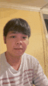 a man in a white striped shirt is looking at the camera .