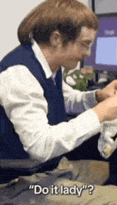 a man is sitting in front of a computer and saying " do it lady " .
