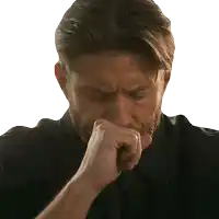 a man with a beard is covering his nose with his hand