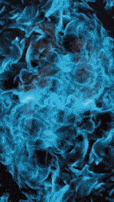 a dark background with blue smoke coming out of the middle