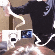 a person is taking a picture with a camera that is attached to their head