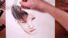 a person is drawing a picture of a man 's face