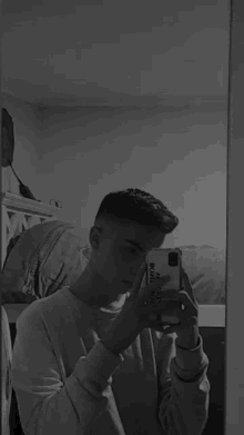 a man is taking a picture of himself in the mirror