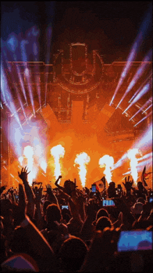 a crowd of people at a concert with the letter u in the middle