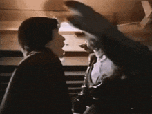 a man in a suit is talking to another man in a suit