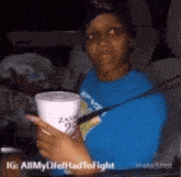 a woman sitting in a car holding a cup that says zaxby 's