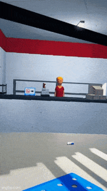 a man in a red shirt is standing on a balcony in a room with a no smoking sign on the wall