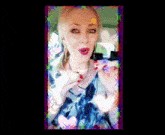 a woman in a blue dress with red nails is surrounded by hearts