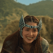 a woman wearing a helmet with wings on it