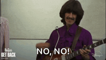 a man in a purple shirt is playing a guitar and saying no .