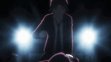 a man in a suit and tie is standing next to a woman in a dark room