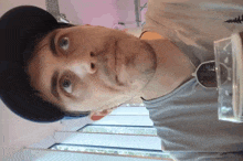 a man wearing sunglasses and a hat looks up at something