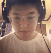 a young man wearing glasses and headphones is looking at the camera