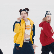 a woman wearing a yellow jacket and a white shirt that says lief
