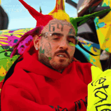 a man with a tattoo on his face has the number 69 on his head