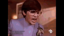 a man with glasses and a tie is making a funny face .