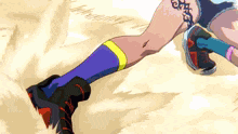 a person with a tattoo on their leg is running in the dirt .