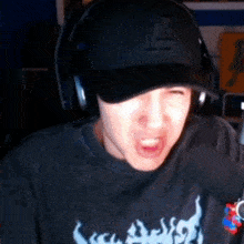 a man wearing headphones and a la hat