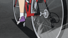 a person riding a bicycle with a purple shoe