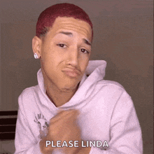 a young man with red hair is wearing a white hoodie and making a face while saying please linda