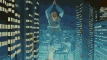 a man is standing on top of a building in a city at night .