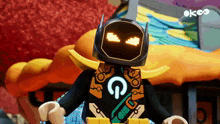 a lego robot with a glowing face and the letter g on his back