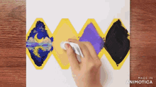 a person is cleaning a painting with a cloth and the words made in animotica are on the bottom