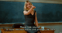 a group of people are sitting at desks in a classroom with a pitcher of pepsi on the table