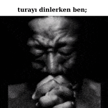 a black and white photo of a man with his hands folded in prayer with a caption that says " turay dinlerken ben "
