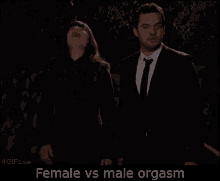 a man and a woman are standing next to each other with the words female vs male orgasm on the screen .