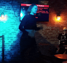 a woman dancing in front of a screen that says vibes