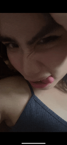 a close up of a woman making a face with her tongue out