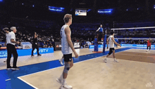 a volleyball game is being played in a stadium with advertisements for btv