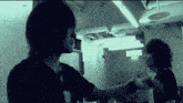 a black and white photo of two people with the letter d visible