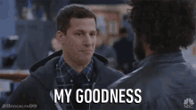 a man says my goodness to another man in a scene from brooklyn 99