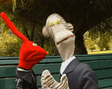a man in a suit and a red hat are standing next to each other