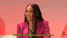 a woman in a pink jacket is smiling and says " you guys will have to watch and see "